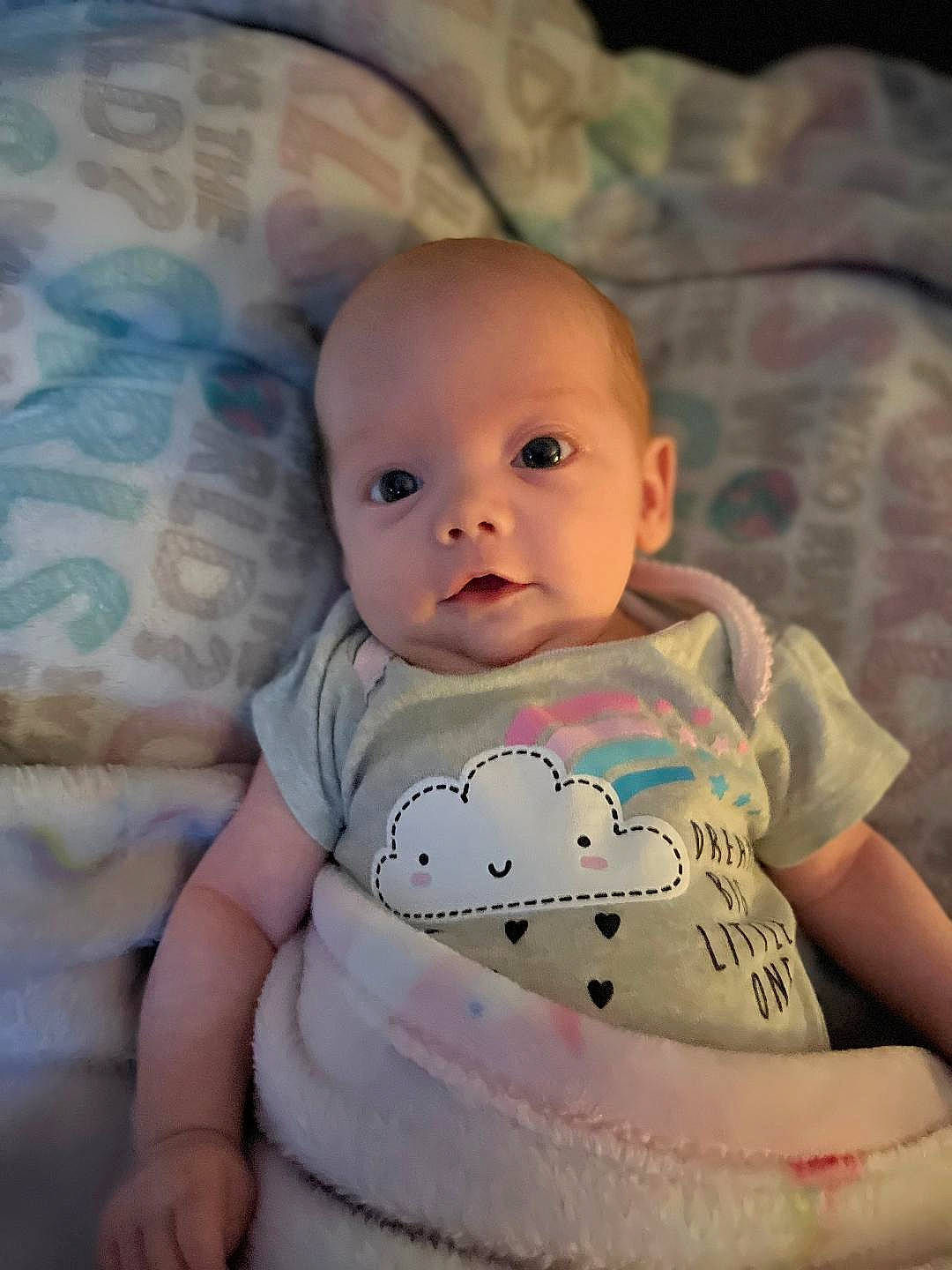 Stormi is registered to the contest to win money with this photo: baby, baby_toddler_clothing, cheek, chin, comfort, eye, eyebrow, flash_photography, happy, iris, lip, mouth, neck, nose, person, pink, skin, sleeve, smile, stomach