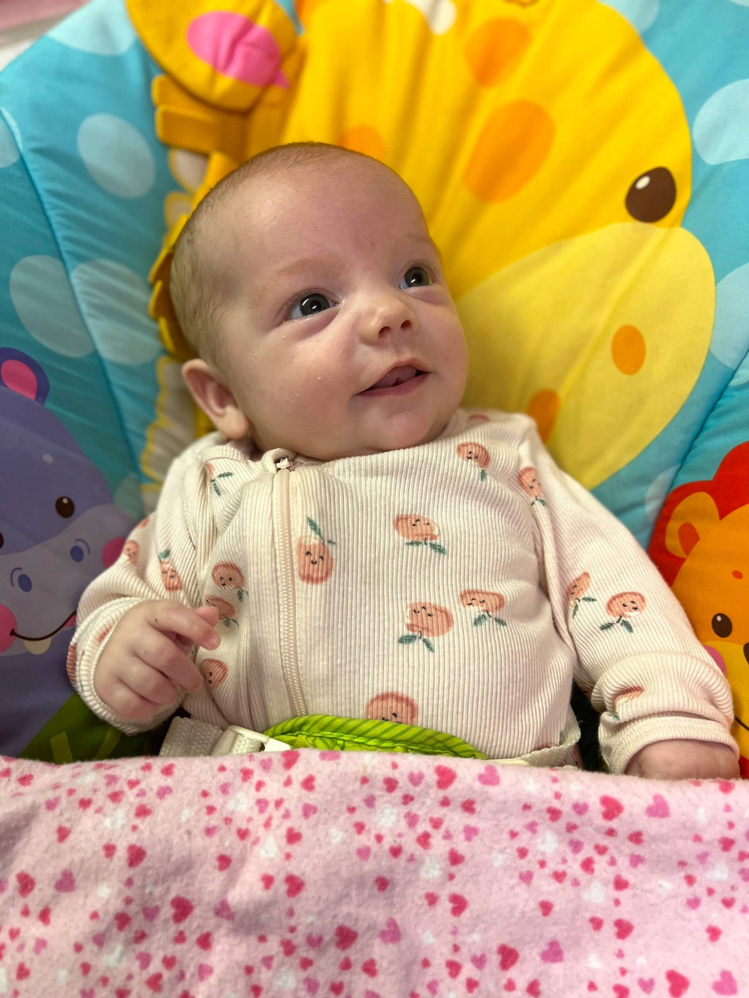 Stormi joined the competition — help win amazing prizes! baby, baby_products, baby_toddler_clothing, bedding, cheek, child, comfort, facial_expression, fun, grass, happy, linens, pattern, person, pink, room, sitting, skin, sleeve, textile
