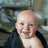 Wyatt is registered to the contest to win money with this photo: baby, smiling, blue_eyes, towel, indoor, closeup, happy, skin, face, tongue, child, infant, cute, portrait, expression, young, person, head, cheerful, soft_background