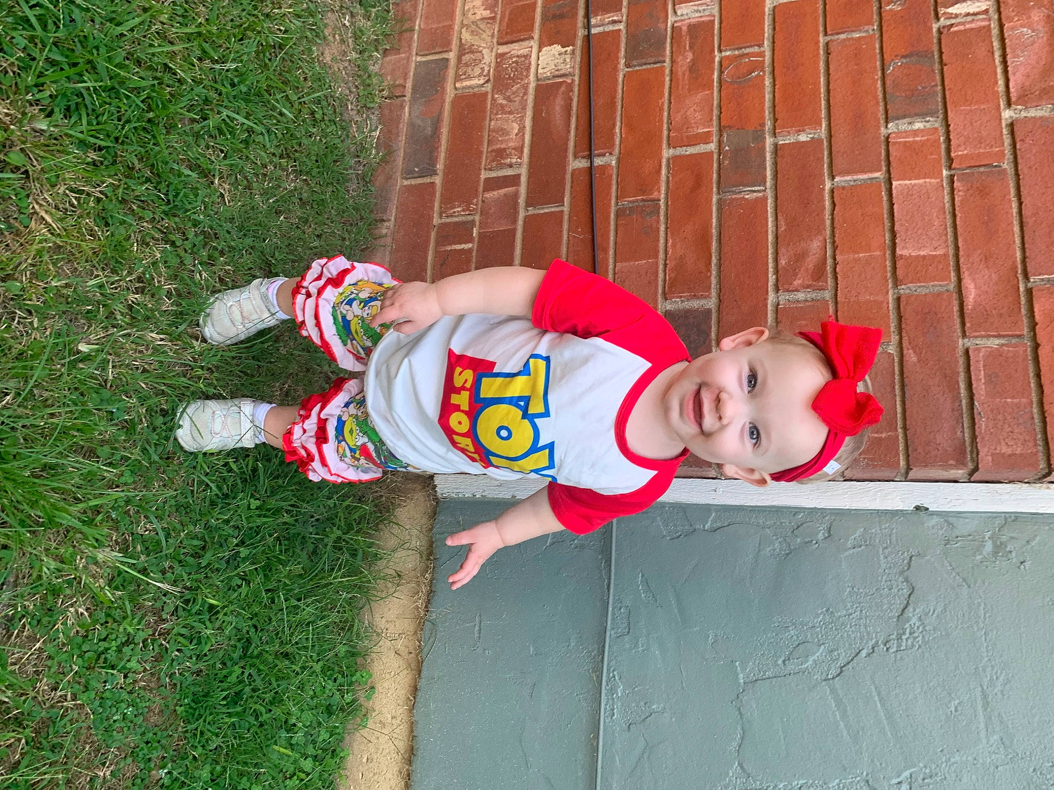 Bryleigh joined the competition — help win amazing prizes! baby_toddler_clothing, brick, brickwork, carmine, child, concrete, flooring, fun, grass, hat, human_leg, joy, pattern, person, plant, sock, t_shirt, thigh, toddler, vertebrate