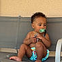 baby, bare_chest, barefoot, bench, casual, child, curly_hair, cute, diaper, gray_bench, indoor, pacifier, person, sitting, skin, striped_strap, texture_wall, thoughtful, toddler, worn_out