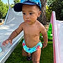 Issa participe au concours pour gagner de l'argent avec cette photo : baby, bare_chest, cap, child, curious, footwear, goggles, grass, greenery, lawn_chair, nature, outdoor, playground, slide, summer, sunlight, swim_diaper, toddler, tree, walking