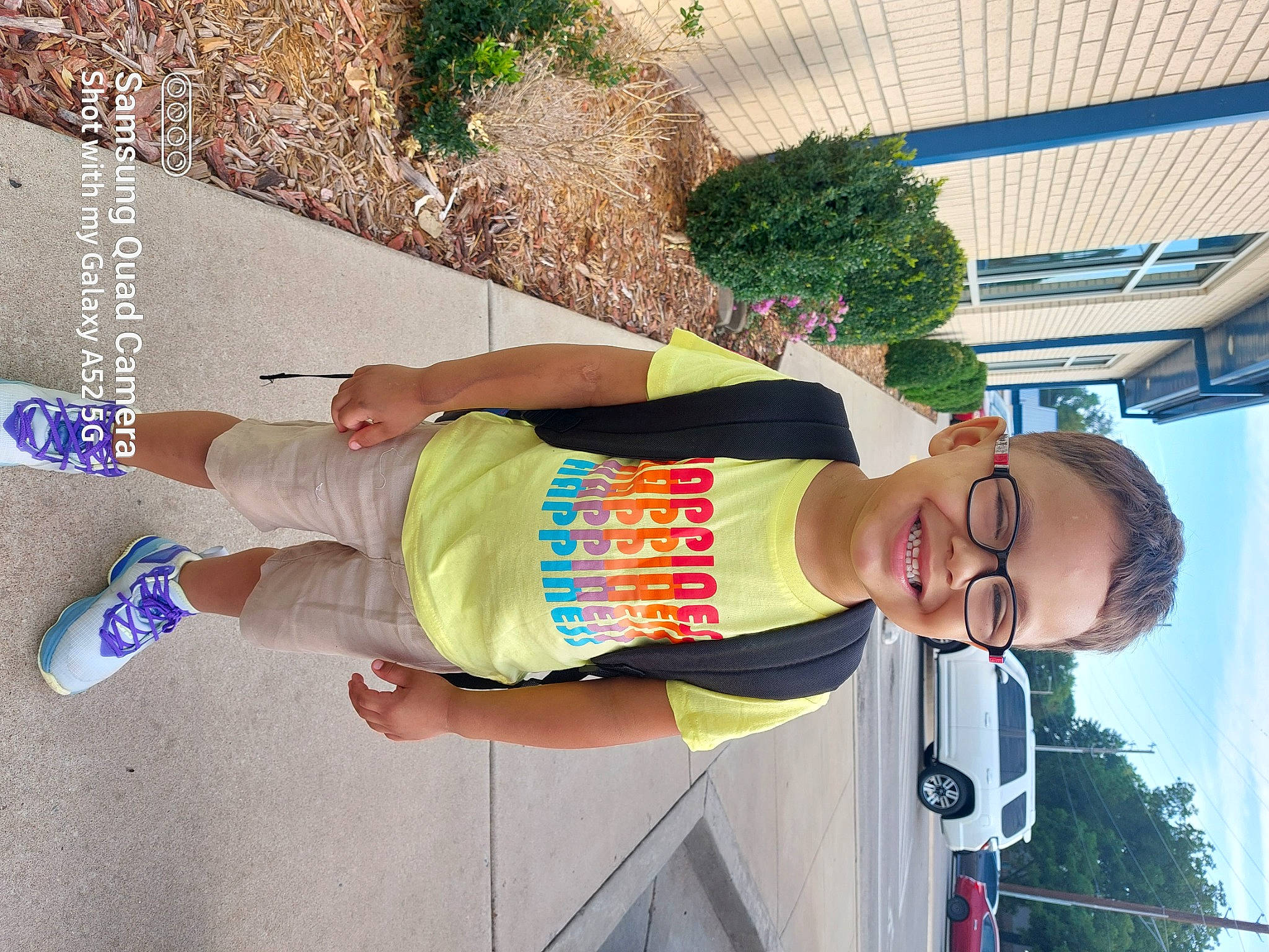 Nehemiah is registered to the contest to win money with this photo: arm, bermuda_shorts, car, elbow, eyewear, fun, happy, hat, human_leg, joy, knee, leisure, person, plant, shorts, sky, smile, t_shirt, thigh, tree