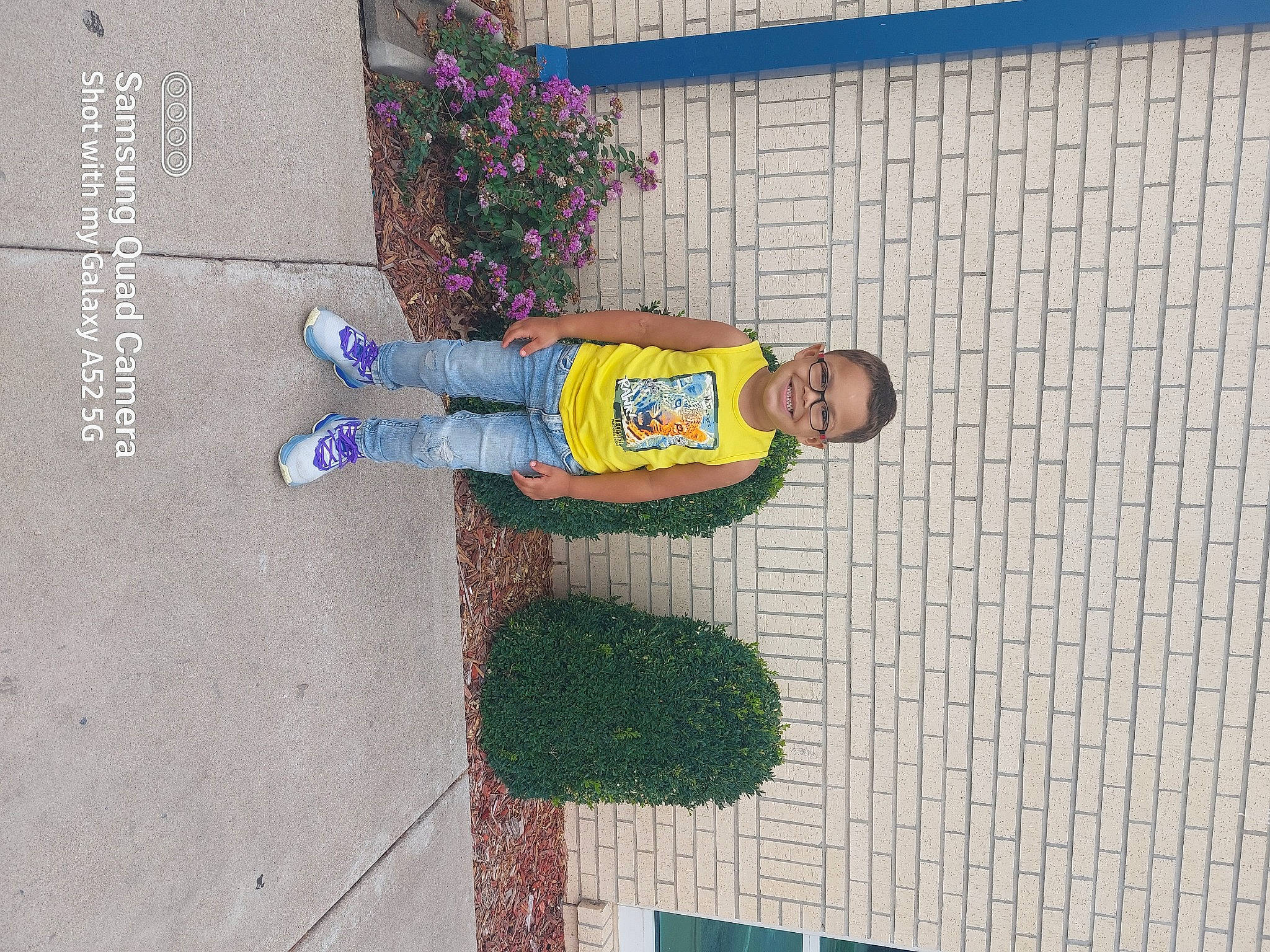 Nehemiah joined the competition — help win amazing prizes! art, asphalt, blue, child, concrete, facade, hat, joy, line, person, plant, road_surface, sidewalk, smile, street, toddler, visual_arts, wall