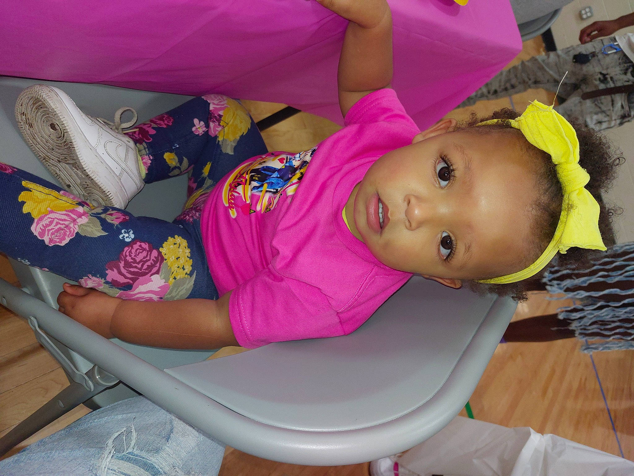 Mariana is registered to the contest to win money with this photo: baby_toddler_clothing, child, comfort, elbow, fun, hat, human_body, human_leg, lap, leg, leisure, magenta, person, pink, product, purple, room, skin, textile, thigh