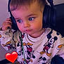 toddler, child, headphones, mickey_mouse, sweater, barefoot, indoor, curious, cute, floor, tile, person, clothing, cartoon_character, red_heart_emoji, young_child, casual_wear, portrait, listening, technology