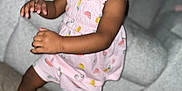 Maliha is registered to the contest to win money with this photo: toddler, child, smiling, pink_dress, fruit_pattern, standing, carpet, couch, indoor, happy, cute, person, young_child, socks, motion, playful, home, living_room, portrait, joyful