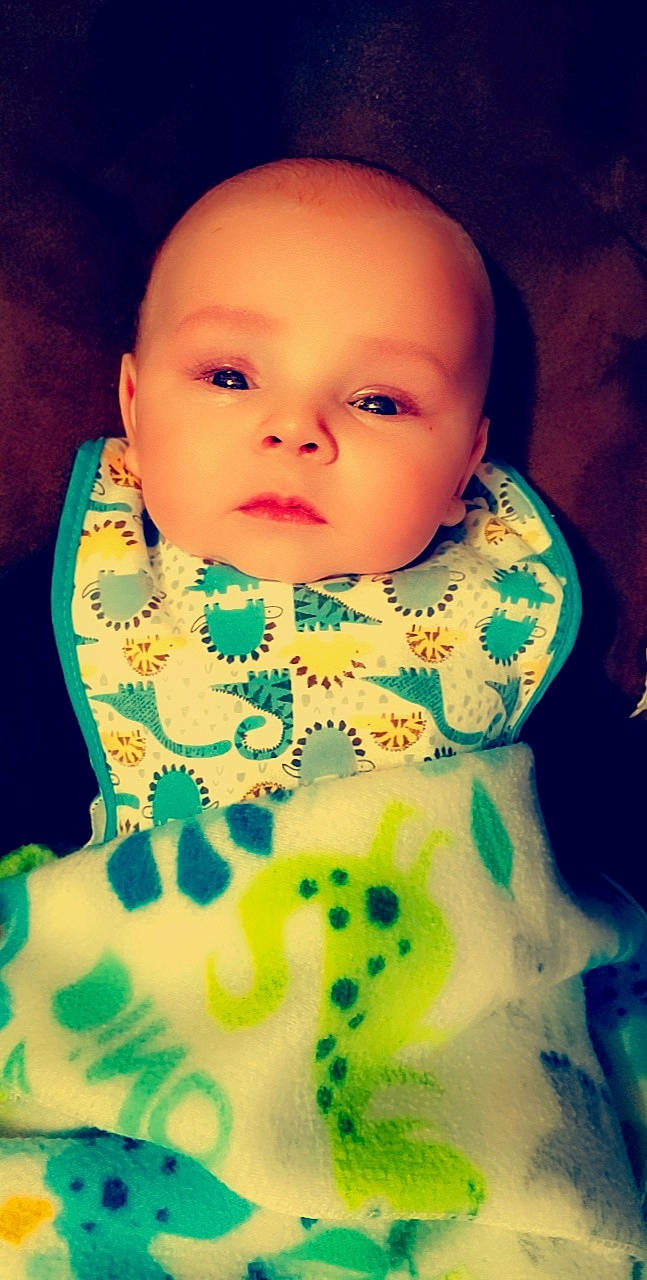 Ryker joined the competition — help win amazing prizes! baby, baby_toddler_clothing, bib, cheek, child, close_up, cool, electric_blue, eyelash, happy, linens, lip, magenta, neck, pattern, person, portrait_photography, sitting, sleeve, textile