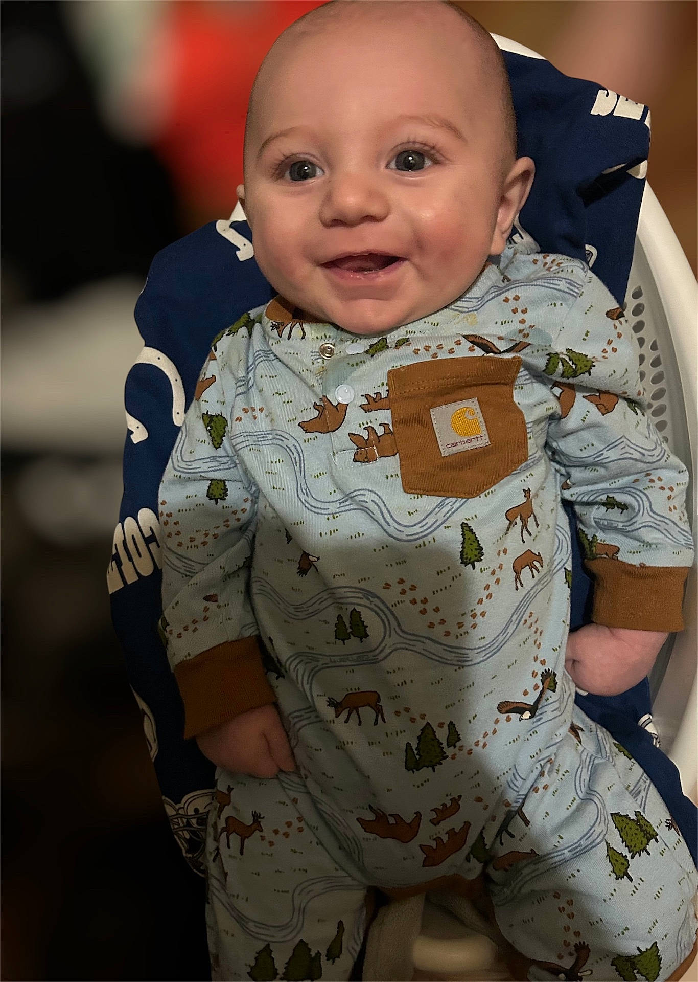 Lincoln joined the competition — help win amazing prizes! baby, candid, chubby_cheeks, clothing, cozy, cute, deer_pattern, eyes, face, forest_print, hands, highchair, indoors, infant, onesie, pocket, portrait, seat_cover, smiling, soft_lighting
