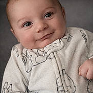 Lincoln joined the competition — help win amazing prizes! baby, infant, face, smile, eyes, onesie, clothing, soft, cute, portrait, child, young, happy, skin, head, human, expression, cozy, indoors, closeup