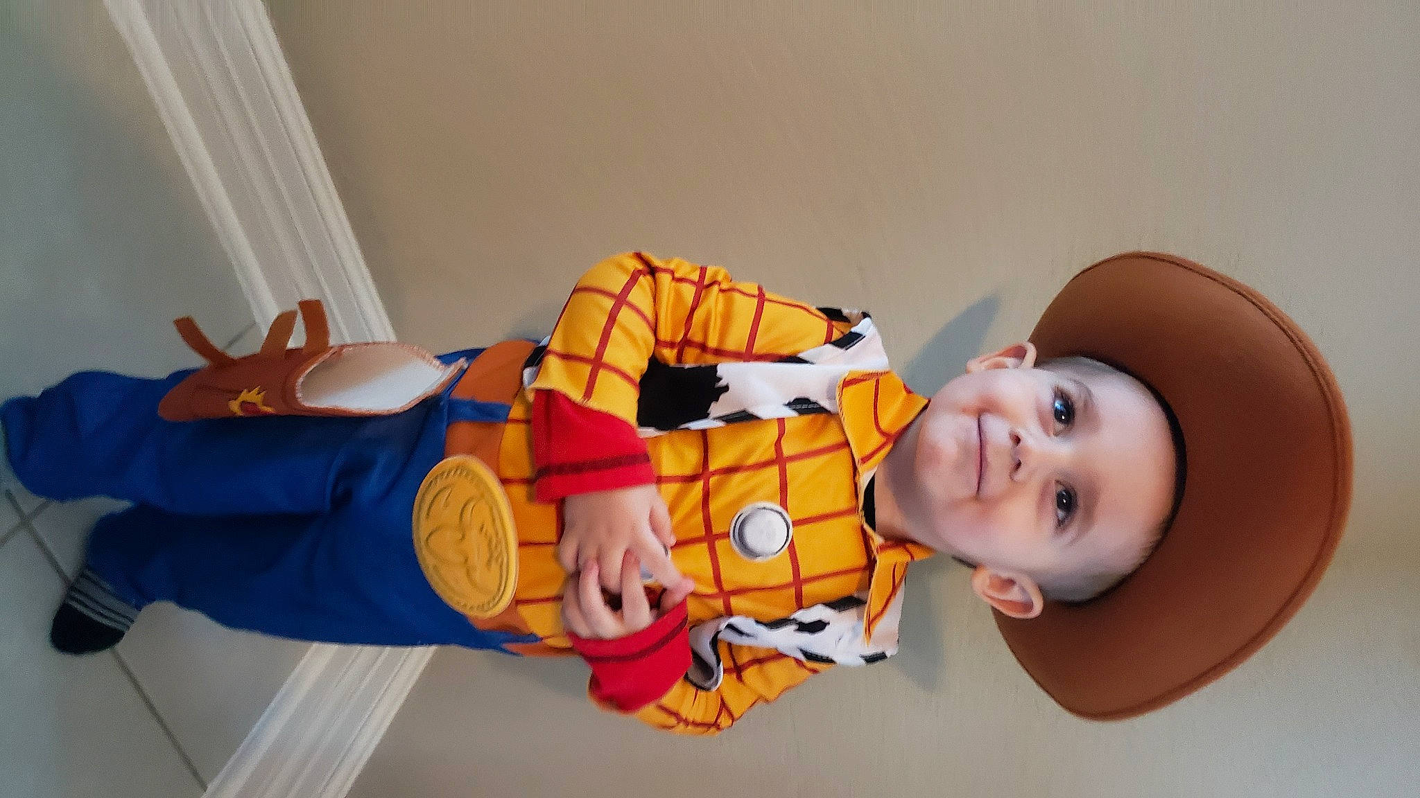 Luke is registered to the contest to win money with this photo: baby, baby_products, child, comfort, facial_expression, finger, fun, happy, human_body, human_leg, joy, knee, leg, orange, person, room, smile, stuffed_toy, thigh, toddler