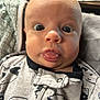 Taylor joined the competition — help win amazing prizes! babies, baby, baby_clothes, blanket, child, clothing, cute, expression, face, head, indoor, infant, newborn, onesie, person, portrait, skin, surprised, tongue, wide_eyes