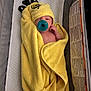 Taylor is registered to the contest to win money with this photo: baby, pacifier, towel, yellow, hood, bee, infant, sleeping, wrapped, cozy, bassinet, blanket, cute, soft, child, newborn, resting, indoor, person, comfort