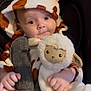 Emmylou is registered to the contest to win money with this photo: baby, infant, giraffe_onesie, hood, ears, plush_toy, sheep_toy, car_seat, seatbelt, cute, cozy, clothing, child, soft_toy, hands, face, expression, indoor, portrait, smile