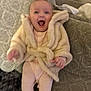baby, child, infant, smiling, laughing, coat, jacket, fur, couch, furniture, indoors, happy, person, seated, clothing, warm, cute, cozy, expression, home
