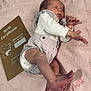 newborn, baby, sleeping, blanket, knitwear, birth_certificate, folder, foot, hand, infant, cozy, pink, star_pattern, clothing, portrait, peaceful, cute, laying, soft, indoor