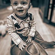 Owen joined the competition — help win amazing prizes! baby, child, clothing, costume, cowboy, cute, eyes, floor, fun, hands, happy, hat, indoor, infant, person, playful, portrait, sitting, smile, young