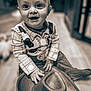baby, child, clothing, costume, cowboy, cute, eyes, floor, fun, hands, happy, hat, indoor, infant, person, playful, portrait, sitting, smile, young
