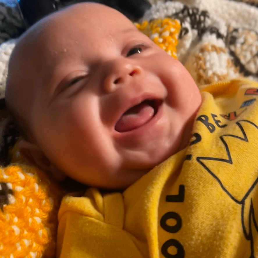 Alaric is registered to the contest to win money with this photo: baby, babylaughing, blanket, bodypart, crying, face, finger, gun, hand, happy, head, laughing, newborn, person, photography, portrait, sad, sleeping, smile, weapon