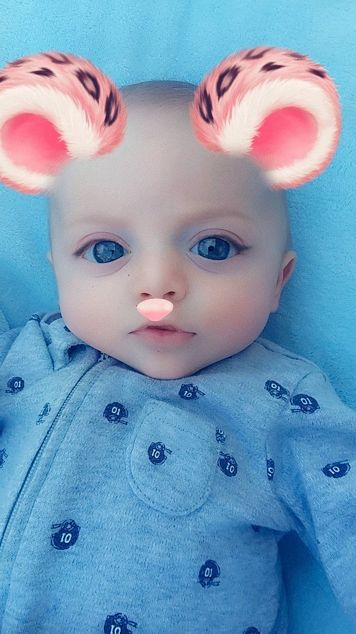 Ary is registered to the contest to win money with this photo: blue, cheek, child, close_up, doll, ear, eye, face, head, infant, iris, lip, mouth, nose, organ, person, pink, skin, toddler, toy