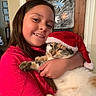Jack N Jill is registered to the contest to win money with this photo: animal, cat, child, christmas, cute, decoration, embrace, face, festive, fur, girl, happy, holding, holiday, home, indoor, pet, red_shirt, santa_hat, smile