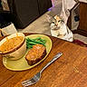 Jack N Jill joined the competition — help win amazing prizes! cat, calico_cat, table, food, green_beans, meatloaf, bowl, soup, fork, wooden_table, chair, towel, couch, indoor, floor, tile_floor, dining, curious_cat, pet, meal