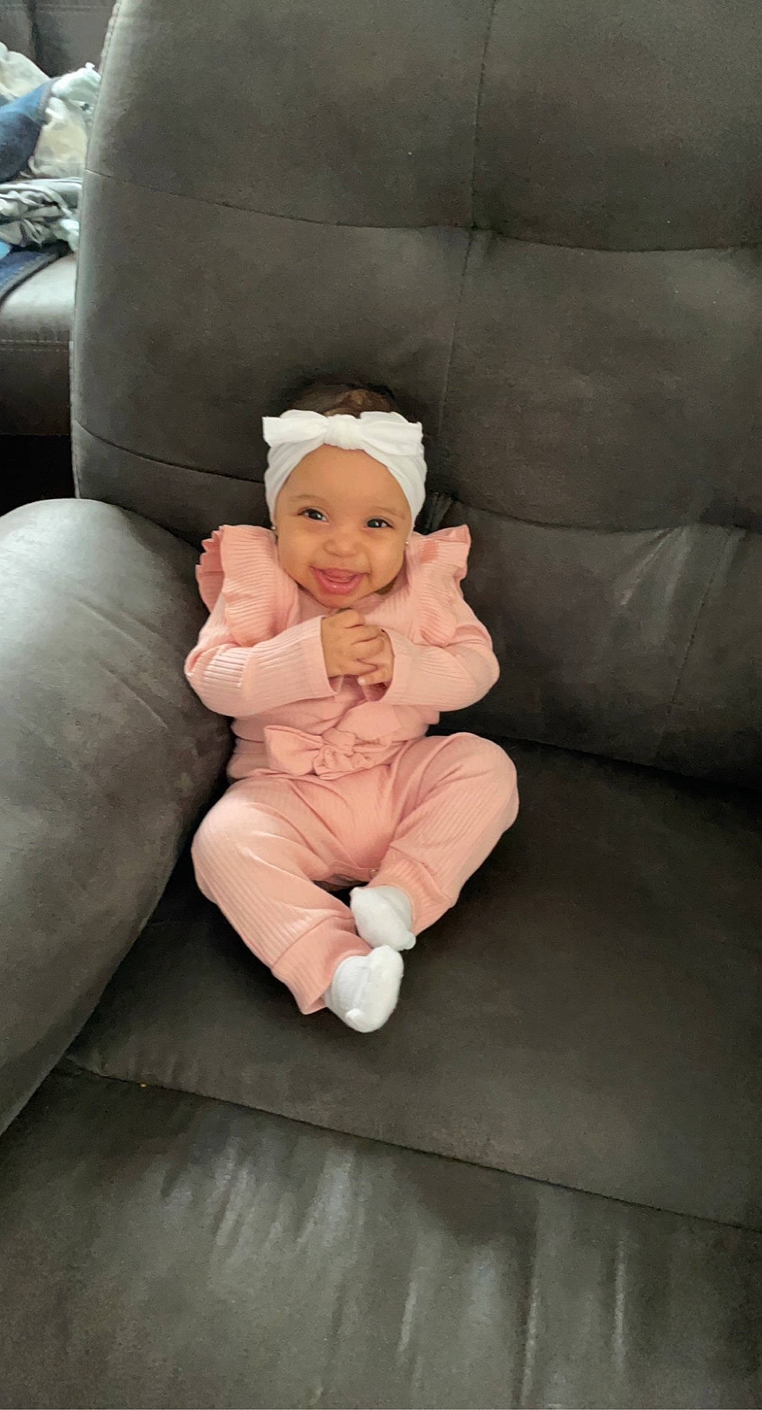 Wylie is registered to the contest to win money with this photo: baby, baby_toddler_clothing, cheek, child, comfort, couch, flooring, foot, fun, fur, headwear, human_leg, joy, knee, lap, linens, person, room, sitting, sleeve
