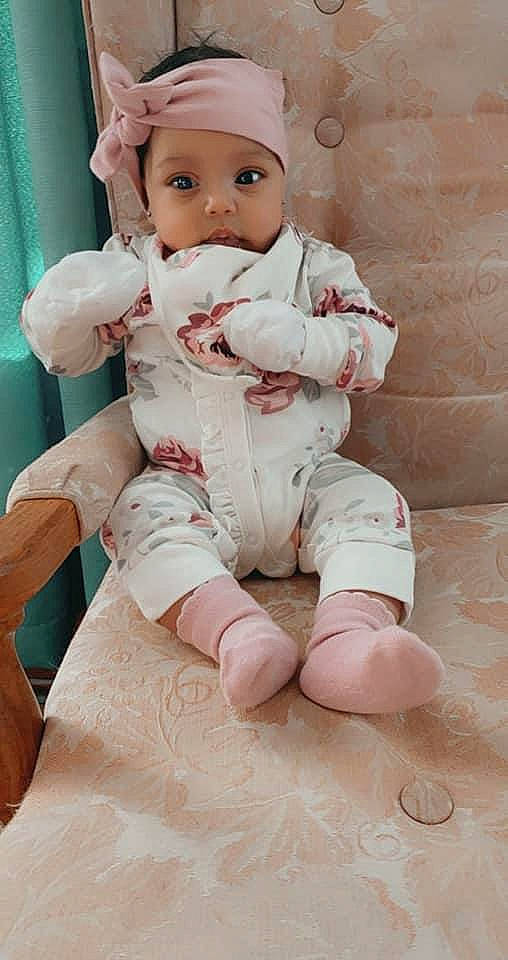 Wylie is registered to the contest to win money with this photo: baby, baby_toddler_clothing, barefoot, carmine, cheek, child, comfort, eye, face, finger, foot, headwear, human_leg, knee, leg, lip, person, pink, skin, sleeve