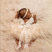 Dynasti is registered to the contest to win money with this photo: baby, blanket, bodypart, bonnet, clothing, dress, face, fashion, finger, hand, happy, hat, head, newborn, person, photography, portrait, sitting, sleeping, smile