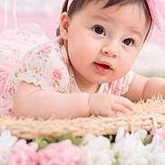 Anyelina Antonella joined the competition — help win amazing prizes! baby, child, infant, pink_bow, floral_dress, basket, flowers, cute, portrait, tummy_pose, soft_light, indoors, headband, curious, young_child, closeup, adorable, pastel_colors, skin, face