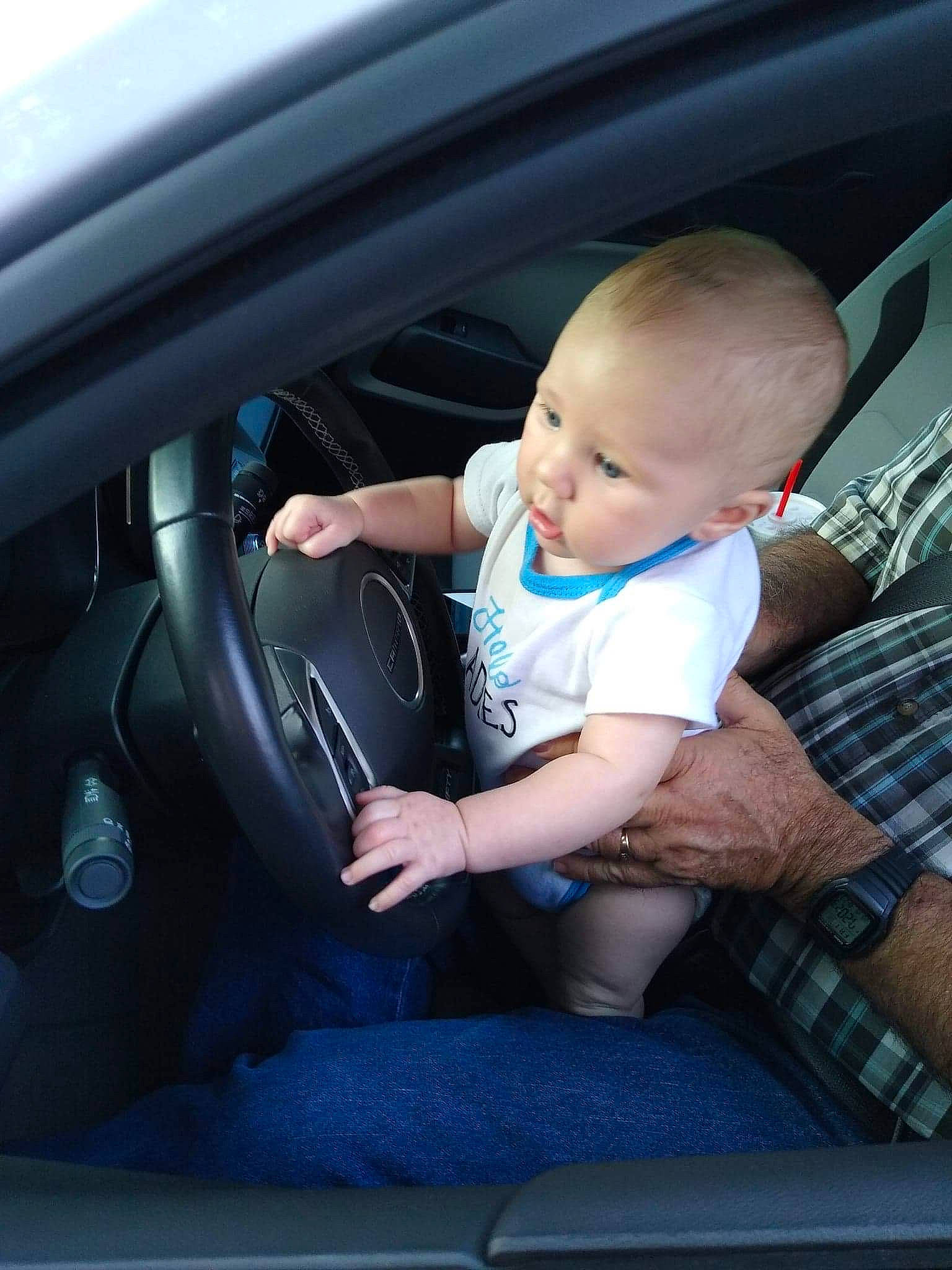 Greyson is registered to the contest to win money with this photo: auto_part, automotive_exterior, automotive_window_part, baby, baby_in_car_seat, car, car_seat, car_seat_cover, child, driving, family_car, luxury_vehicle, person, personal_luxury_car, sitting, steering_part, steering_wheel, toddler, vehicle, vehicle_door