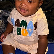 Terrence is registered to the contest to win money with this photo: baby, bodypart, clothing, couch, cushion, face, finger, furniture, hand, happy, head, homedecor, hosiery, person, photography, portrait, shorts, sitting, sock, t_shirt