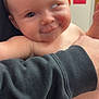 baby, infant, diaper, smile, face, skin, arm, hand, adult, clothing, black_sweatshirt, holding, indoor, person, closeup, expression, cheek, red_mark, candid, playful