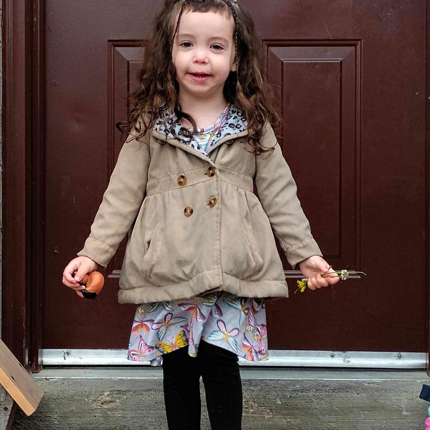 Araya joined the competition — help win amazing prizes! bow, butterfly, casual_clothing, child, coat, concrete, curly_hair, door, doormat, dress, flowers, girl, happy, heart, outdoor, person, smiling, sneakers, standing, toy