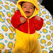Messiah joined the competition — help win amazing prizes! baby, infant, smiling, winnie_the_pooh, onesie, hood, yellow, red, blanket, pattern, cute, happy, child, portrait, face, clothing, indoors, soft, cozy, lying_down