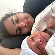 Noel joined the competition — help win amazing prizes! person, newborn_baby, blanket, hat, face, lying_down, closeup, indoor, skin, expression, portrait, comfort, hospital_blanket, cuddle, mother_and_baby, resting, sleepy, human, tenderness, family