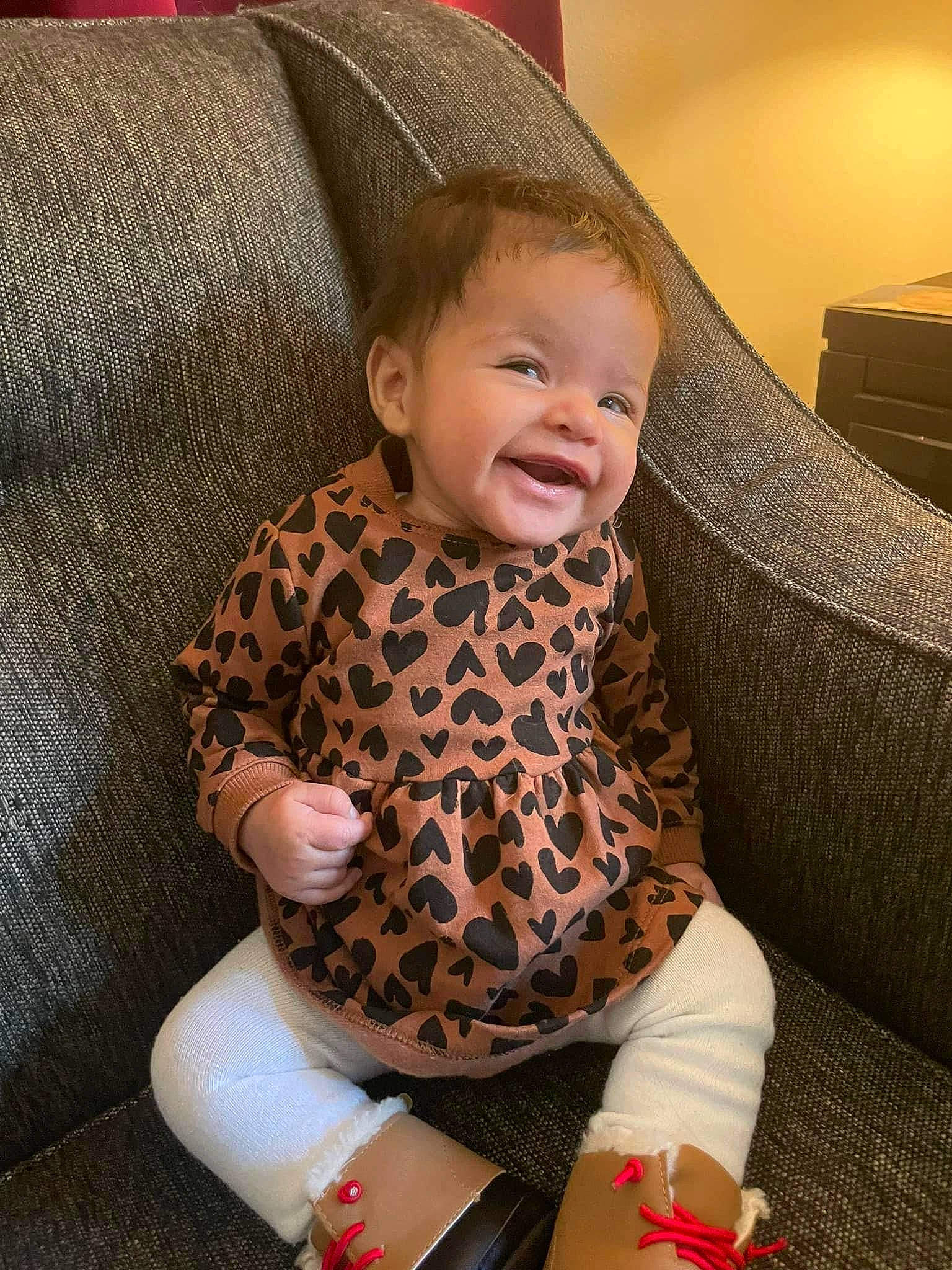 Kinslee is registered to the contest to win money with this photo: baby, baby_toddler_clothing, comfort, couch, flooring, human_body, human_leg, knee, lap, leg, outerwear, pattern, person, skin, sleeve, smile, sock, textile, thigh, toddler