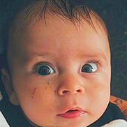 Mason is registered to the contest to win money with this photo: baby, brown_hair, child, close_up, clothing, eyes, face, head, indoor, infant, mouth, nose, people, photograph, portrait, pout, rosy_cheeks, serious_expression, wet_hair, wide_eyes