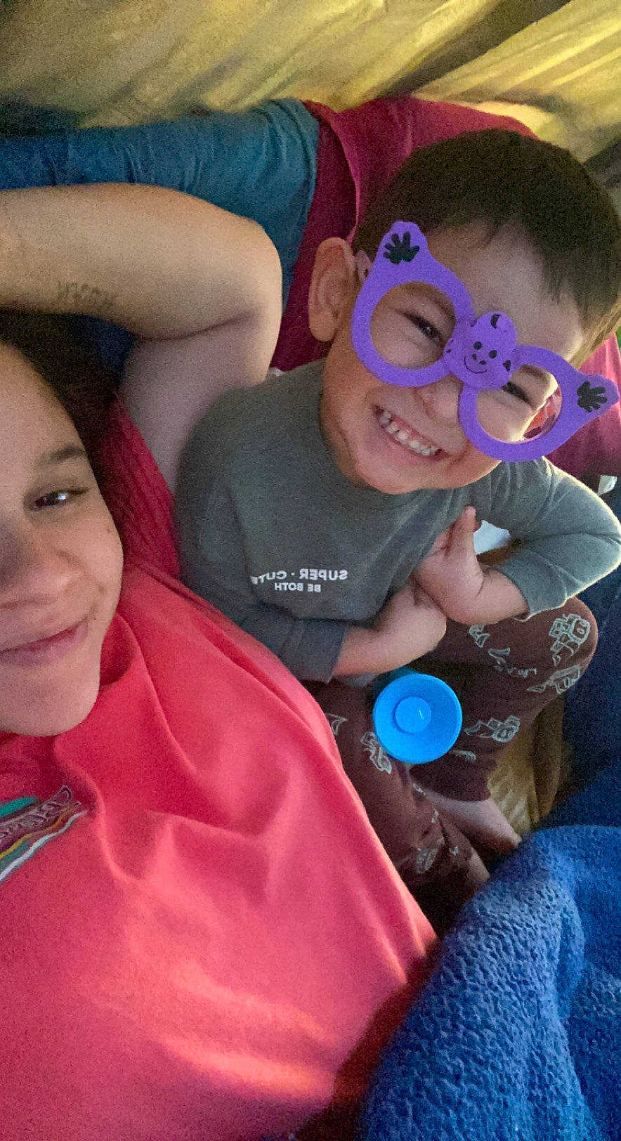 Noah is registered to the contest to win money with this photo: azure, blue, cool, eye, eyewear, facial_expression, finger, fun, happy, head, human, interaction, joy, mouth, organ, person, pink, skin, smile, t_shirt