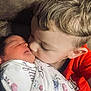 affection, baby, blanket, child, closeup, comfort, couch, face, family, hair, indoor, kiss, love, newborn, portrait, red_shirt, sibling, skin, swaddle, toddler