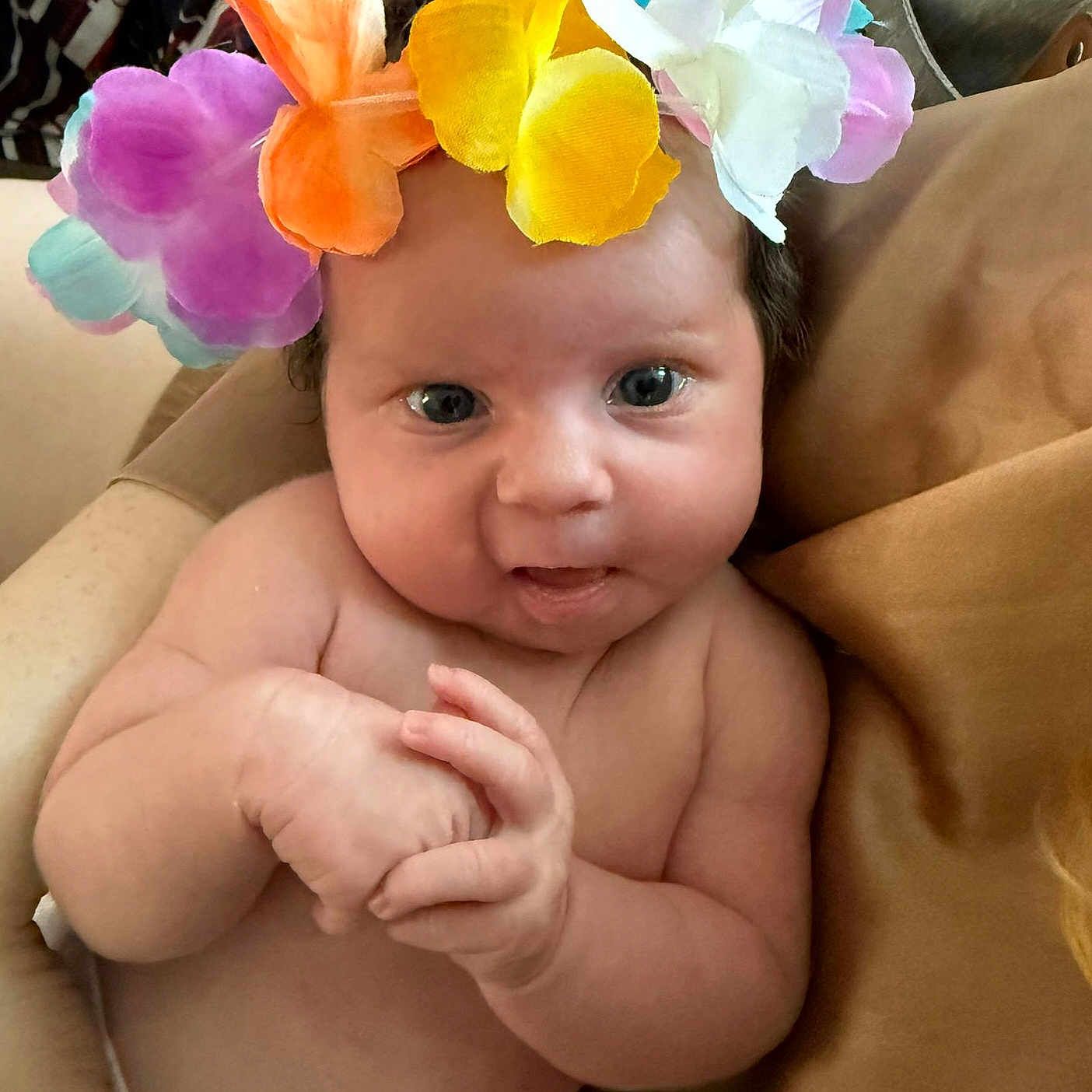 Sophie-Louise is registered to the contest to win money with this photo: baby, blanket, blue_eyes, cheeks, child, closeup, clothing, comfort, couch, cute, expression, face, flower_crown, hands, indoors, infant, portrait, skin, soft_lighting, toddler