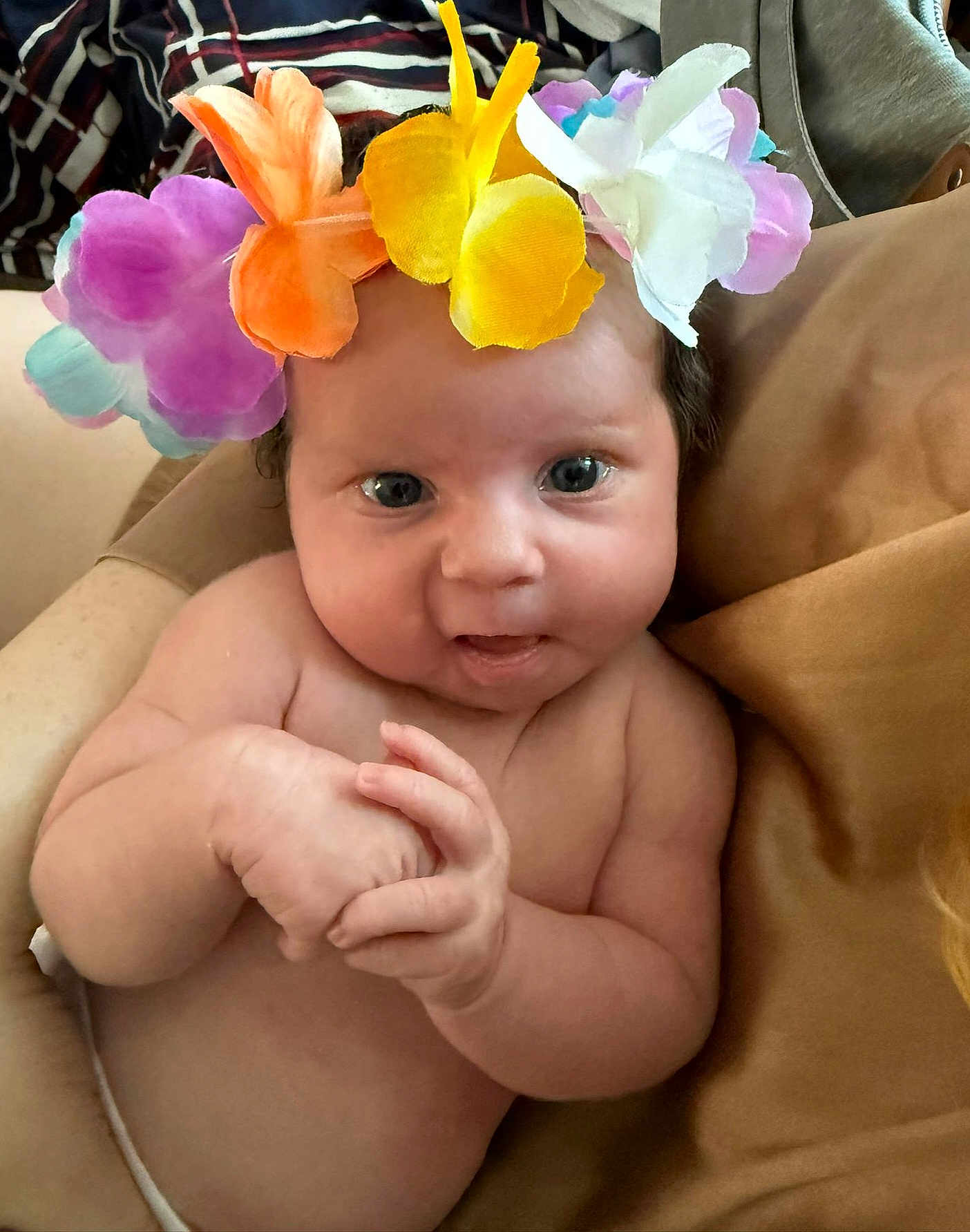 Sophie-Louise is registered to the contest to win money with this photo: baby, infant, flower_crown, hands, skin, face, blue_eyes, cheeks, couch, blanket, comfort, cute, indoors, portrait, toddler, expression, soft_lighting, child, clothing, closeup