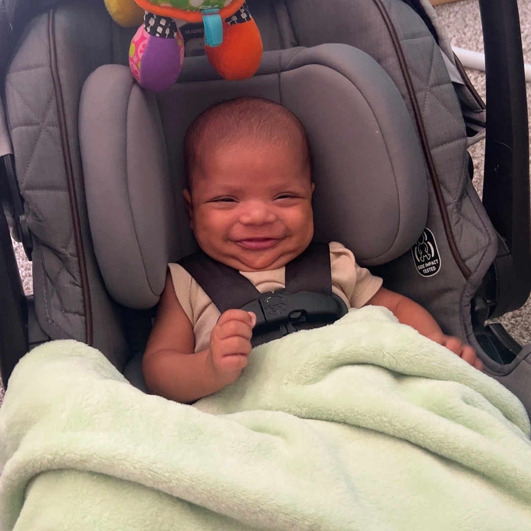 Hezakiah joined the competition — help win amazing prizes! baby, blanket, car_seat, child, colorful, comfort, cozy, cute, happy, head, indoor, infant, person, playful, seatbelt, small, smiling, soft, toy, turtle