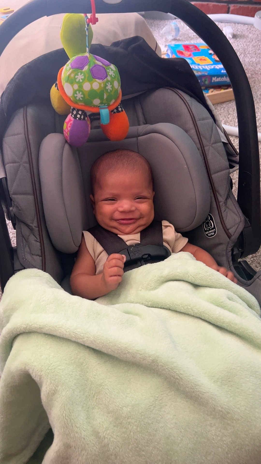 Hezakiah joined the competition — help win amazing prizes! baby, smiling, car_seat, blanket, toy, turtle, infant, child, indoor, happy, cute, seatbelt, soft, colorful, head, person, small, cozy, comfort, playful