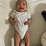 Hezakiah is registered to the contest to win money with this photo: baby, infant, smiling, onesie, bed, blanket, sleepwear, happy, lying_down, human, skin, child, cute, mouth_open, hands, legs, shadow, fabric, pattern, indoor