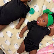 Rasohn-Remedy is registered to the contest to win money with this photo: baby, infant, blanket, crib, headband, hat, onesie, lying_down, cute, toddler, child, indoors, soft_toys, colorful_blanket, sock, sleepwear, expression, family, nursery, resting