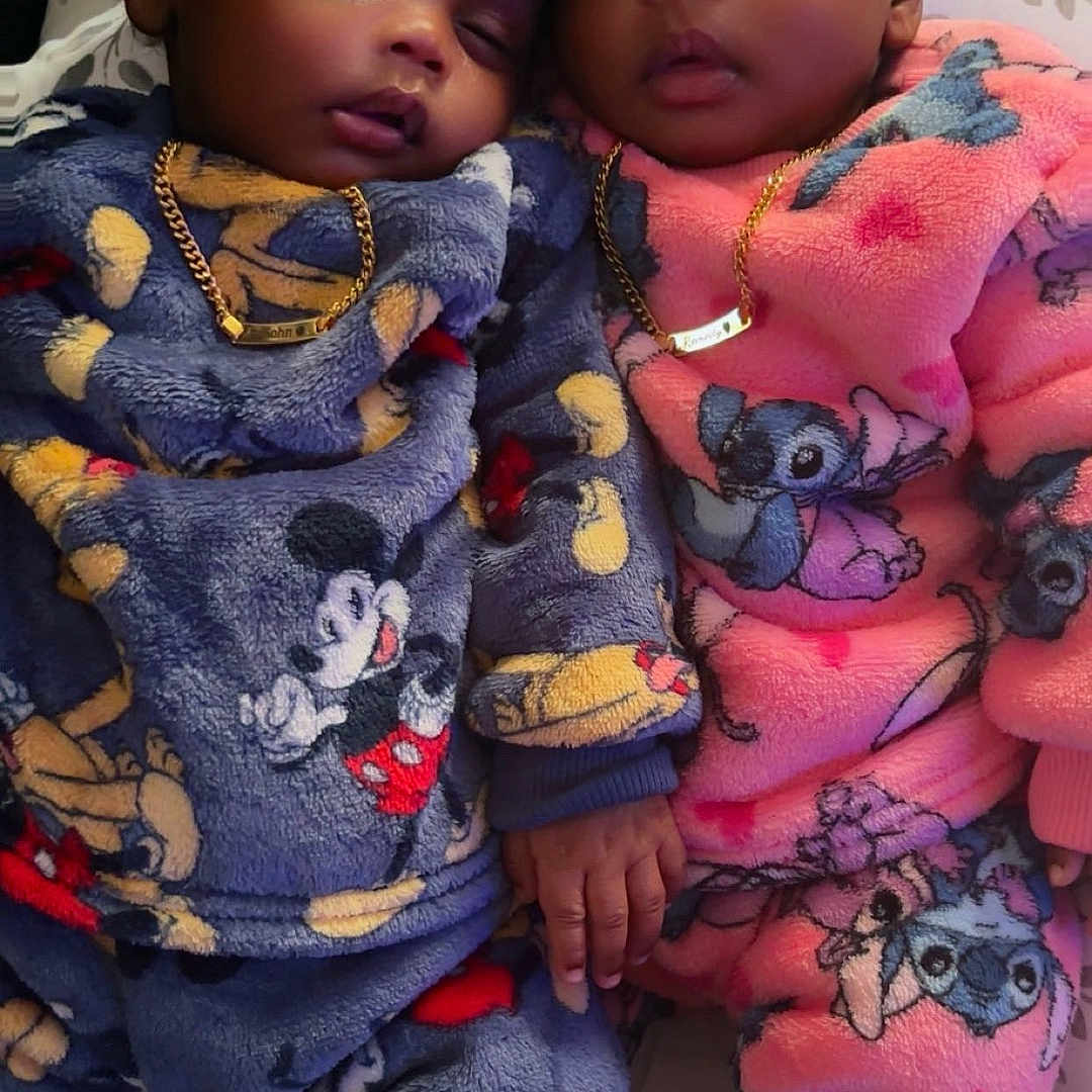 Rasohn-Remedy is registered to the contest to win money with this photo: bed, blanket, child, clothing, cozy, cute, face, gold_chain, hand_holding, headband, indoor, infant, mickey_mouse, pajamas, peaceful, people, portrait, sleeping, stitch, toddler