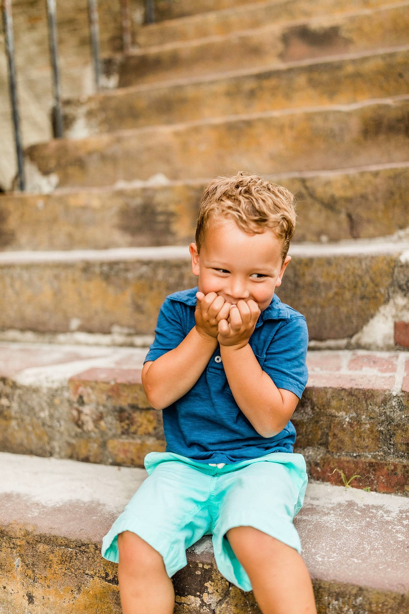 Jared is registered to the contest to win money with this photo: brick, cheek, child, child_model, chin, fun, happy, nose, person, photograph, photography, play, portrait, portrait_photography, sitting, smile, stone_wall, toddler, turquoise, vacation