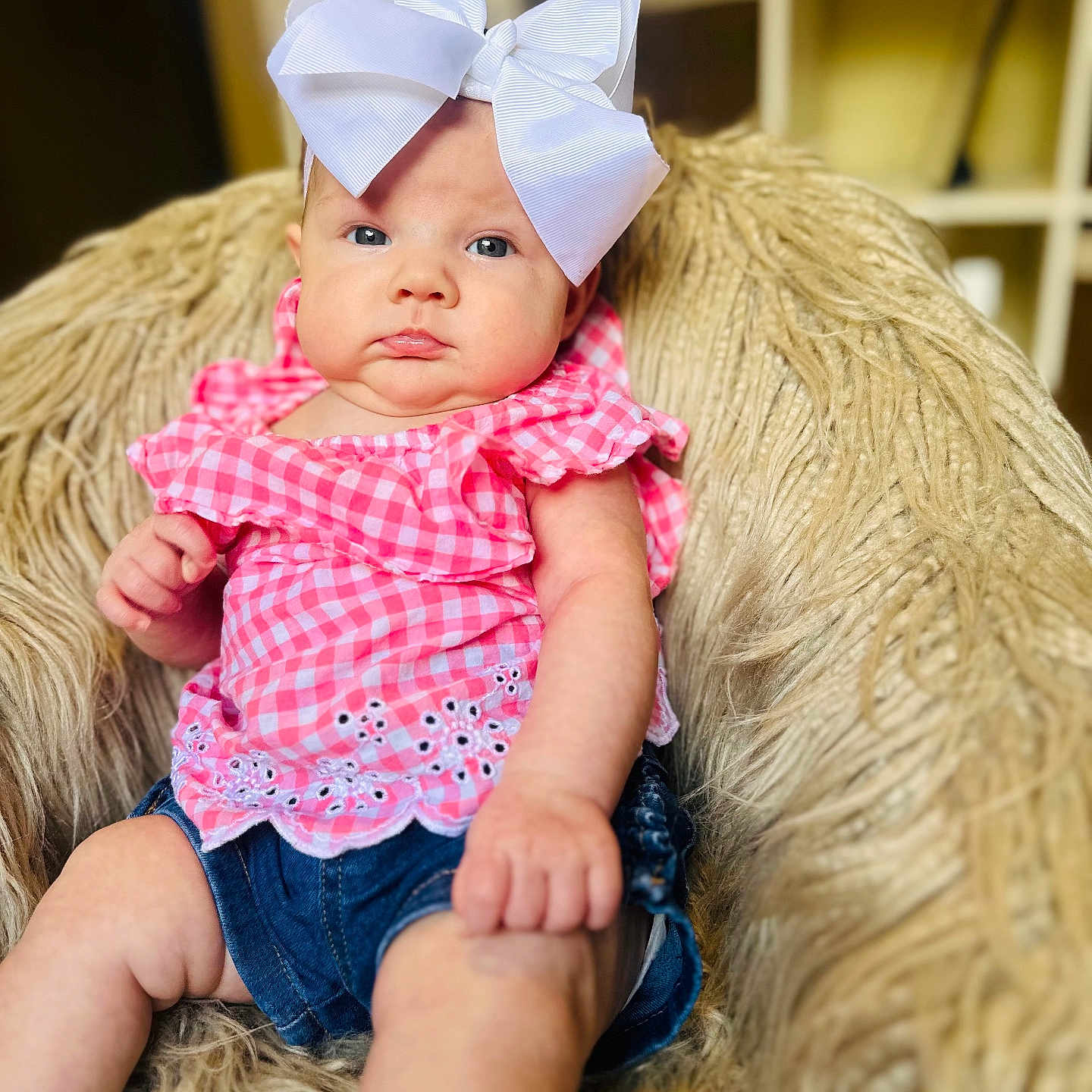 Hadley joined the competition — help win amazing prizes! baby, blue_eyes, bow, casual, chair, child, curious, cute, denim_shorts, fashion, headwear, indoor, infant, pink_clothing, plush_chair, portrait, pout, sitting, soft_texture, young_child