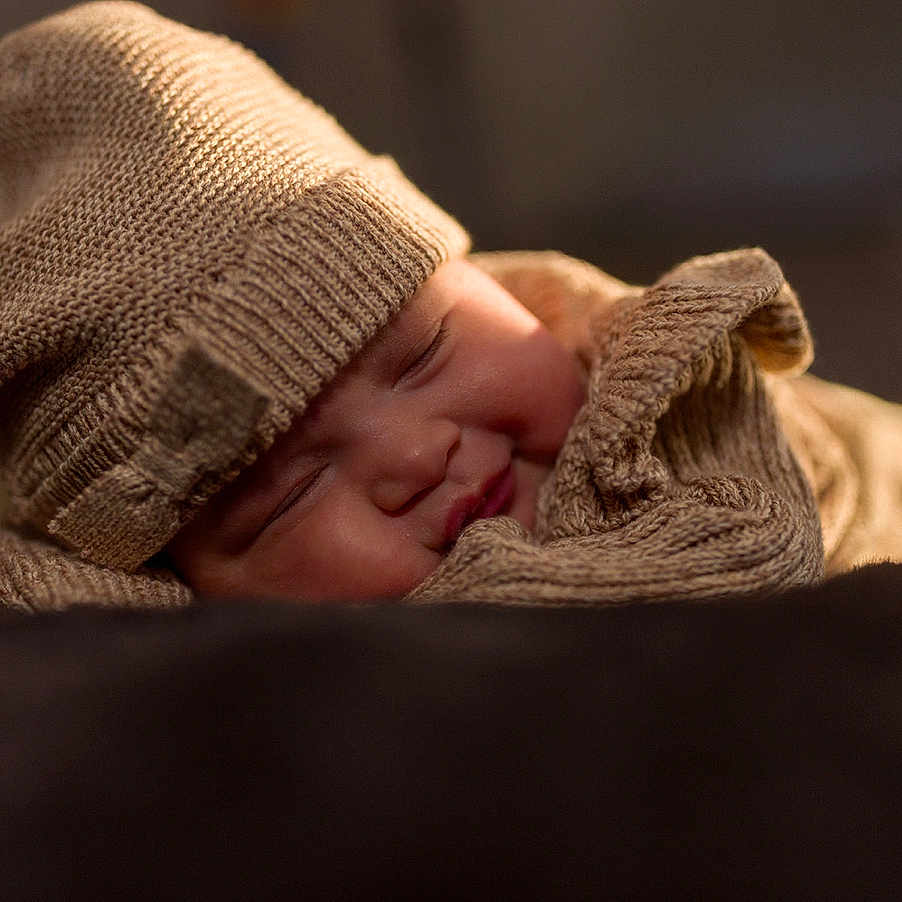 Savannah is registered to the contest to win money with this photo: baby, beanie, bodypart, bonnet, cap, clothing, face, finger, glove, hand, hat, head, hood, hoodie, knitwear, newborn, person, sweater, sweatshirt